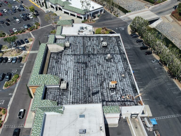 Aerial view commercial roof Southern California shopping center.