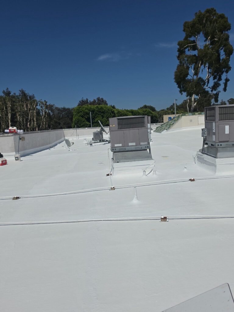 Commercial rooftop with HVAC units, Southern California trees background
